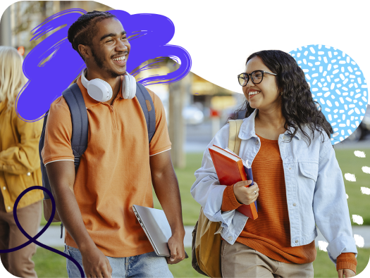 Three students talking and laughing while holding books.