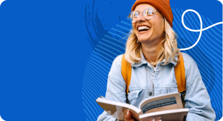 Smiling student holding a book.